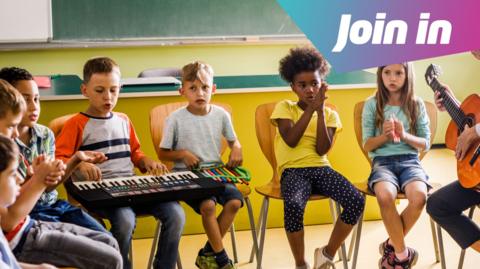 childen playing music together