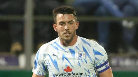 Niall Canavan playing for Barrow on a wet night at Holker Street