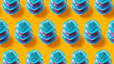 Pattern in plastic lunch boxes with vegetables a yellow background