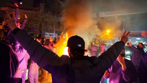  Fires are lit as protesters rally on January 8, 2026 in Tehran, Iran. 