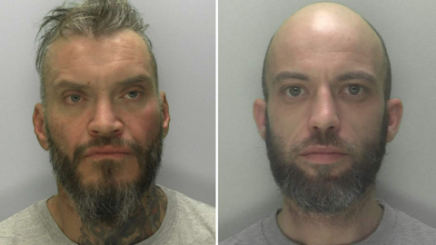 Two custody images of Rowbotham and Rice. Rowbotham has short greasy hair, swept back from his face, a dark grey beard and a large dark tattoo on his neck. Rice is bald, with a short greying beard. Both wear grey t-shirts. 