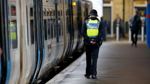 Police officer near train