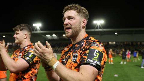 Angus O'Brien applauds supporters after Dragons beat Lyon in the Challenge Cup