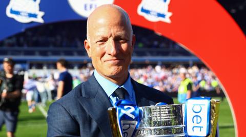 Tom Wagner, chairman of Birmingham City, poses for a photo with the EFL League One Trophy