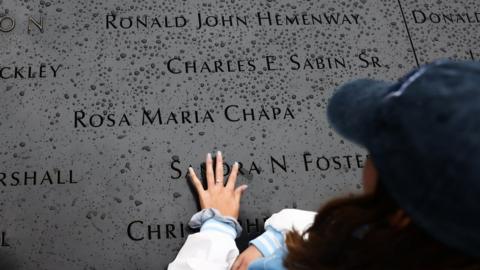 Hand touching memorial