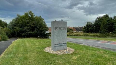 Grey plinth statue saying 'Ryhope' and hooves stuck on top.