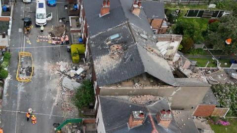 An aerial view of damage to a terrace row of houses