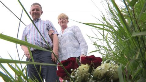 Grant Weir and Michele Nixon lay flowers at the scene of the bomb attack in which he was injured