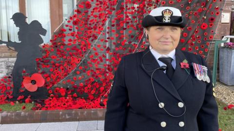 Petty Officer Rosy Hearn at a wall of poppies in Llandudno