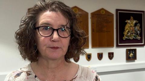 The mayor of Crowborough Town Council, Councillor Natalie Whittle, pictured at the council offices in Crowborough. Natalie has brown shoulder length hair and is wearing glasses. 