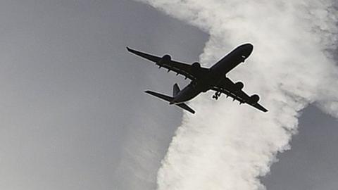 Plane silhouette and contrails