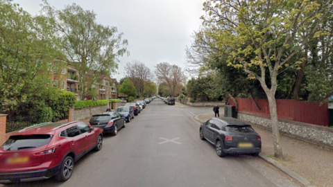  St Botolph’s Road in Worthing. Cars parked either side of a quiet road.