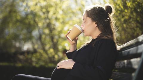 pregnant woman drinking coffee