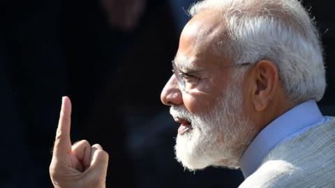 Narendra Modi displays his ink-marked finger after casting his vote during the third phase of general elections at a polling station in Ahmedabad on April 23, 2019.