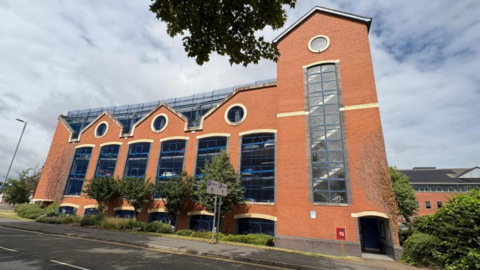 Image showing a multi-storey car park constructed out of red-brick on Beehive Lane.