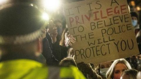 Woman holds up placard at vigil to Sarah Everard at Clapham Common