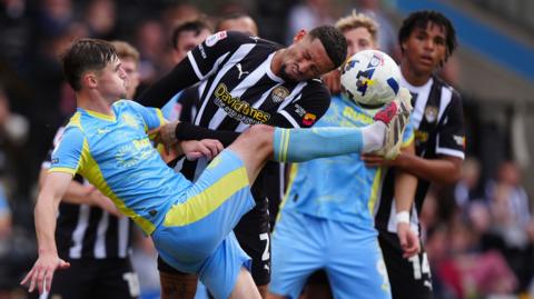 Fleetwood Town's Mark Helm (left) and Notts County's Kellan Gordon battle for the ball during the Sky Bet League Two match at Meadow Lane
