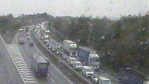 The eastbound direction (to the right of the traffic camera image) is full of cars and lorries stuck in traffic. The image is slightly blurry as the camera has been covered in raindrops from the bad weather.