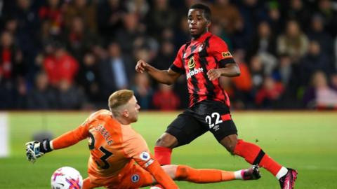 Junior Traore of Bournemouth shoots past Jason Steele of Brighton