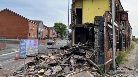 Building with collapsed wall