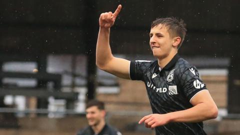 Wrexham's Max Cleworth celebrates his goal at Mansfield