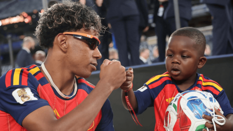 Lamine Yamal and brother Keyne after the World Cup final, with both wearing mainly red and blue Spain shirts