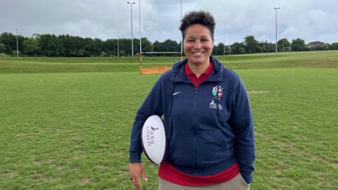 Shaunagh Brown on the pitches at her home club Medway RFC in Rochester holding a Royal London rugby ball