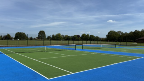 Three tennis courts coloured green and blue