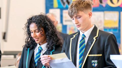 pupils look at exam results