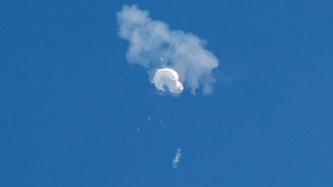 Photo of spy balloon in the air being shot down