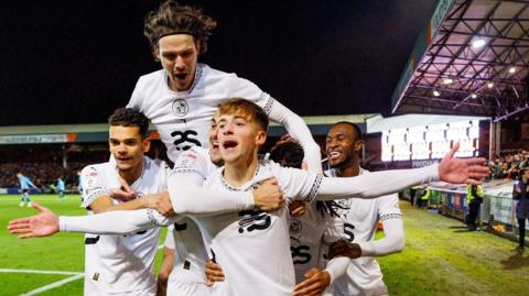 Port Vale's Jack Shorrock is mobbed by team-mates after his stunning goal against Crewe