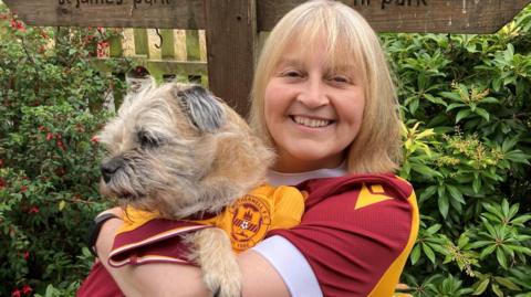 Hilary Little holding her dog Berry