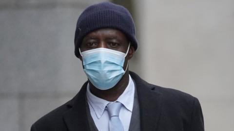 Image of Stephen Kyere wearing a navy blue hat and mask.