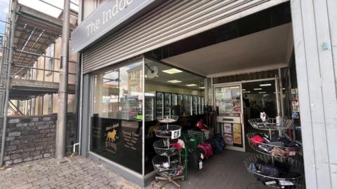 The photo shows the front of Mark's Mobile Butchers in Kingswood. Shutters can be seen above the shop window.
