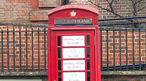 A red phone box, with white windows.