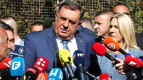 Milorad Dodik (C) gives a statement to journalists, after leaving the State Court of Bosnia and Herzegovina, in Sarajevo in October