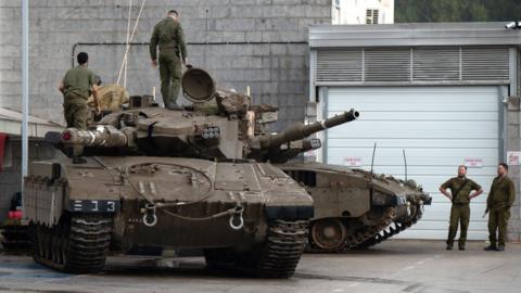 Israeli soldiers with armoured fighting vehicles at an area near the border with Lebanon, in the Upper Galilee, northern Israel, 16 October 2023.