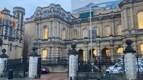 The exterior of Reading Crown Court, a large building with ornate stone columns and arched windows.