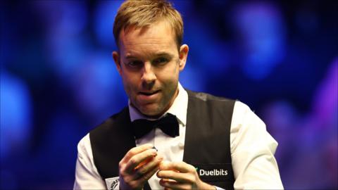 Ali Carter chalks his cue while assessing his options