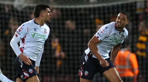 Bolton Wanderers' Xavier Simons (left) celebrates scoring