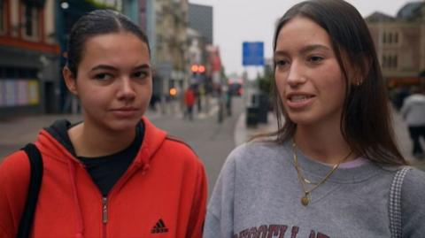 Two young women in a Cardiff street giving their views on young drivers