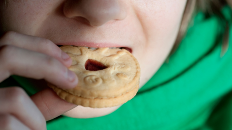 Person eating a Jammie Dodger