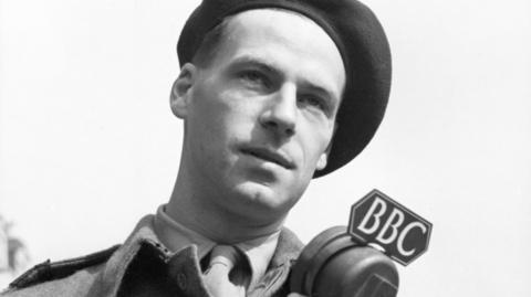 A BBC war correspondent with a BBC microphone.