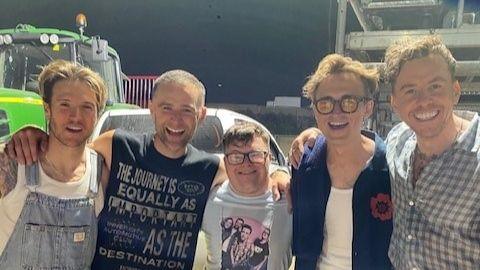 Joel stood with the four members of McFly 