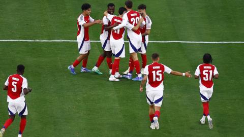 Arsenal players celebrate a goal