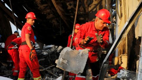 Emergency personnel work at the site following a fatal fire at a wedding celebration, in the district of Hamdaniya in Iraq's Nineveh province, Iraq, on 27 September 2023