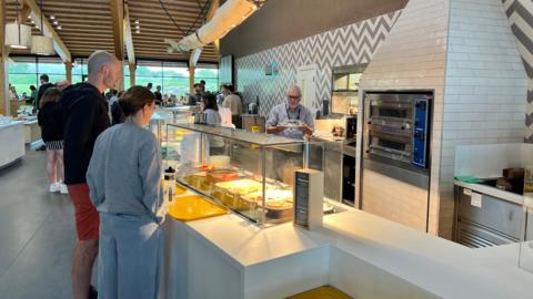 People queueing for food at a canteen-style cafe at Gloucester Services