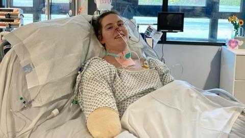 Quadruple amputee Lily McGarry smiles from her hospital bed. 