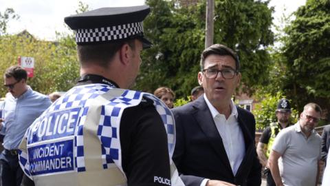 Burnham peaks to the West Midlands Police incident commander during a visit to Stourbridge in the West Midlands