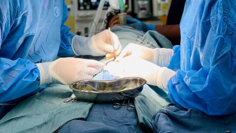 Generic operation shot of staff in scrubs.